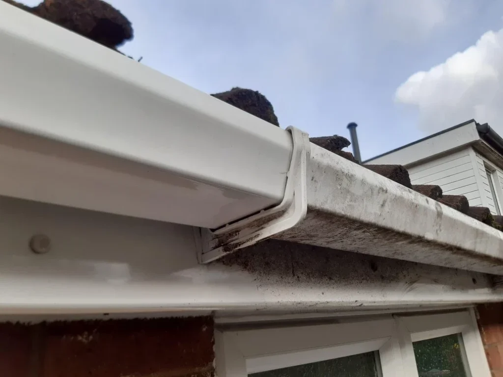 Close-up of dirty white gutter corner.